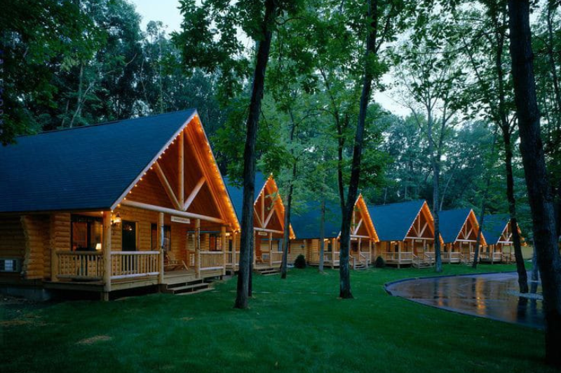 Resort nestled in a forest area, surrounded by tall trees and lush greenery