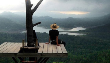 Scenic view of a river flowing through the landscape, surrounded by lush greenery at the resort.