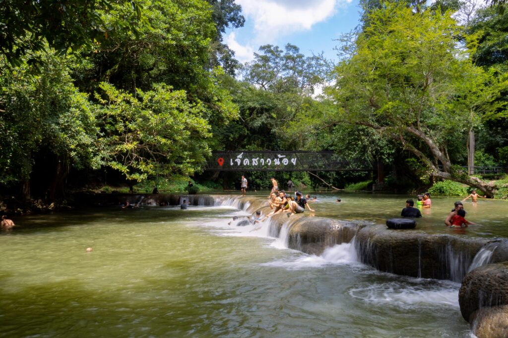 People enjoy a sunny day at Chet Sao Noi waterfall in Muak Lek, Thailand.